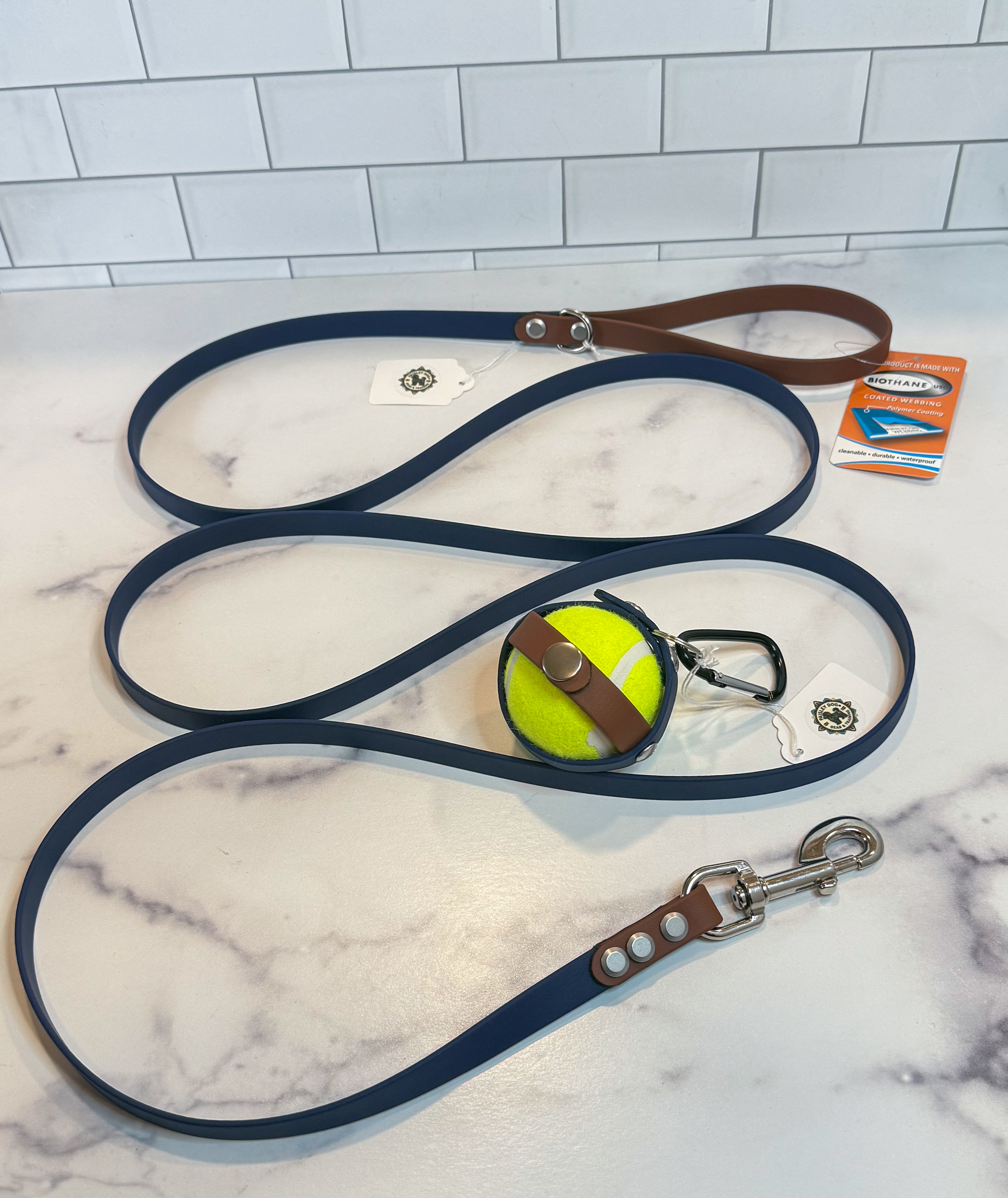 Item: Ball holder + leash set | Width: 5/8 in | Colors: Deep Sea & Brown 522 with matching ball holder | Hardware: silver