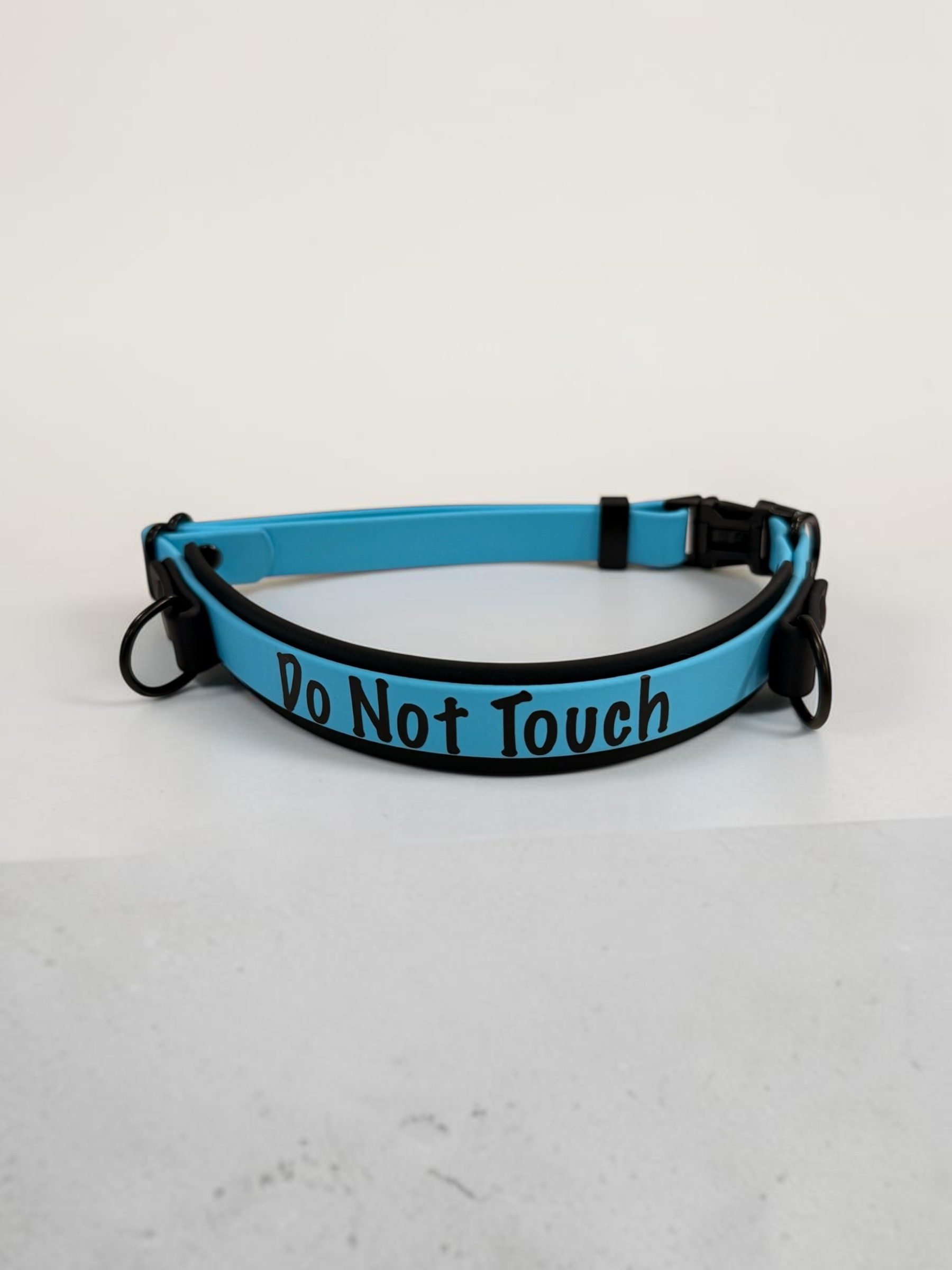 Item: Custom 2-layer collar with detachable handle | Width: Collar is 1 in & 5/8 in, handle is 5/8 in | Colors: Black base with Light Blue accent | Hardware: black | Custom: Integrated control handle for extra grip or quick grab, HTV details on collar