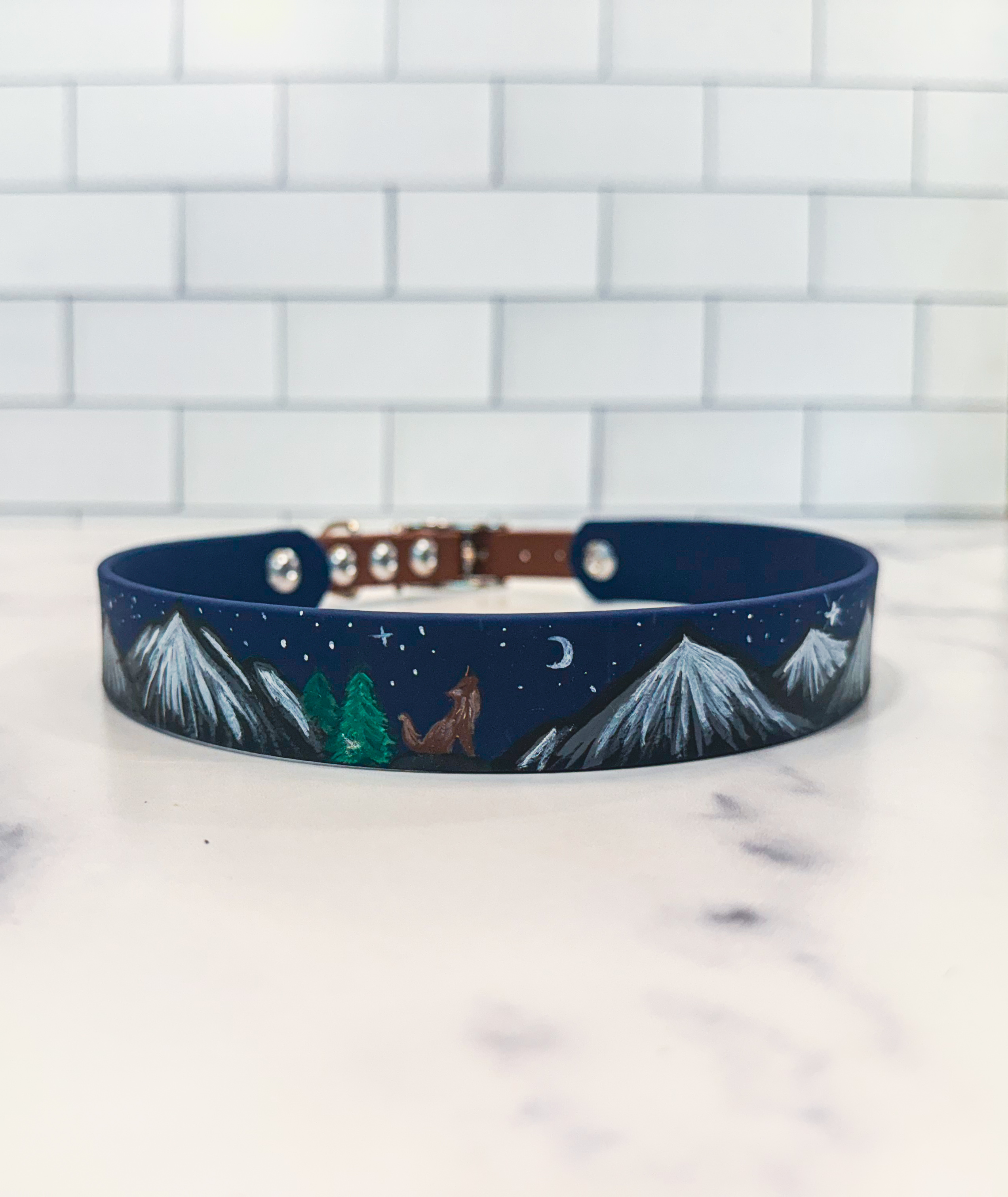 Item: Custom hand-painted collar | Width: 1 in with 5/8 in buckle | Colors: Deep Sea base with hand-painted mountain landscape | Hardware: silver | Custom: Hand-painted design sealed for durability