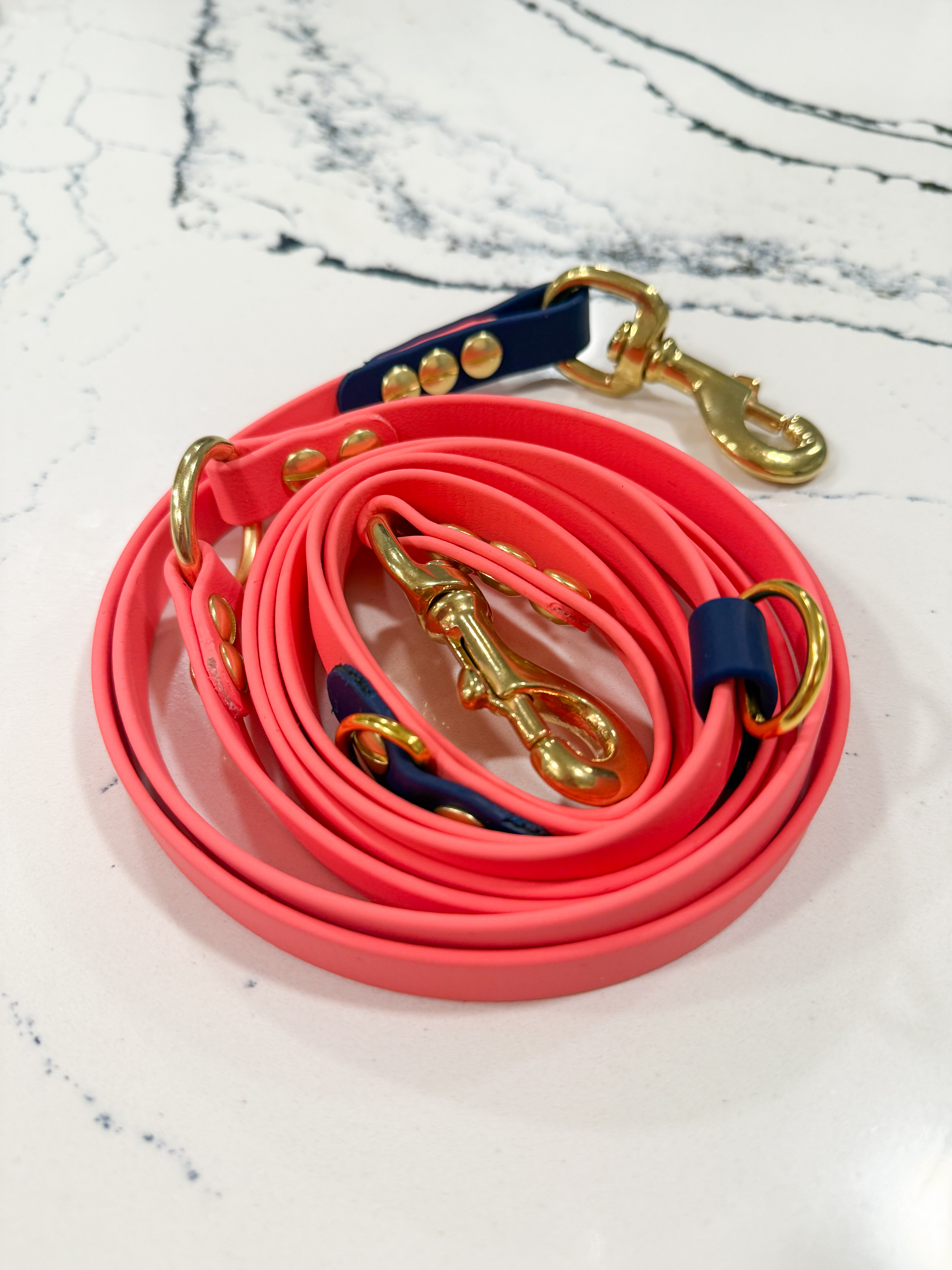 Item: Hands-free system | Length: 7 ft | Width: 5/8 in | Colors: Coral & Deep Sea | Hardware: solid brass | Custom: Multi-way system shown rolled for storage
